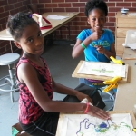Kids learning Mardi Gras Indian design at Xavier's art program
